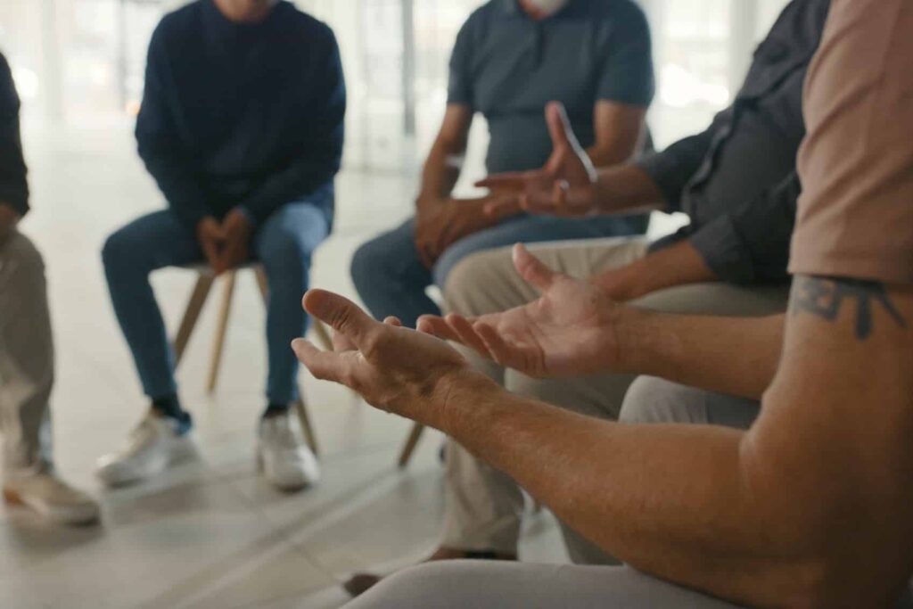 A community group meeting focused on mental health support, illustrating the importance of social connections in the healing process